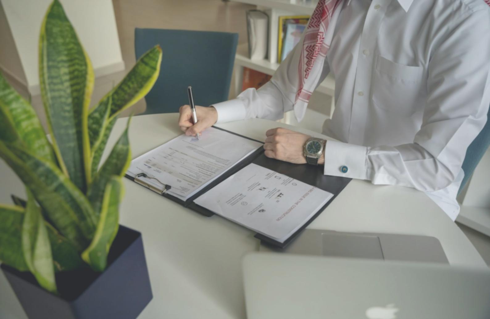 Business planning workspace with documents and financial charts